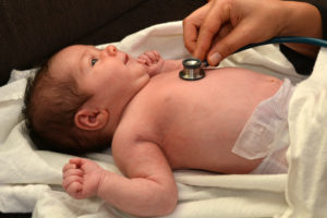 A Doctor Checks A Baby That Is Suspected Of Having Birth Defects Caused By Zoloft